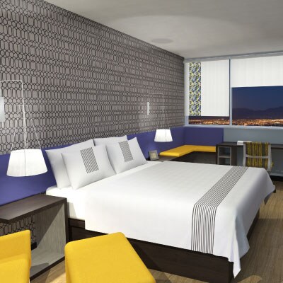 a king bed in a Glo hotel room