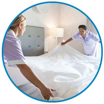 two ladies making a bed