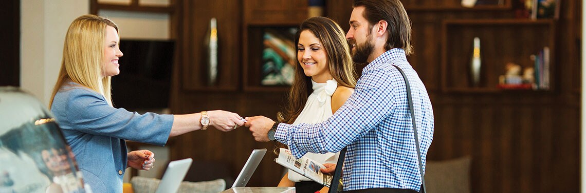 Couple Checking into SureStay Collection Hotel
