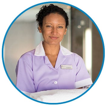 Housekeeper holding towels