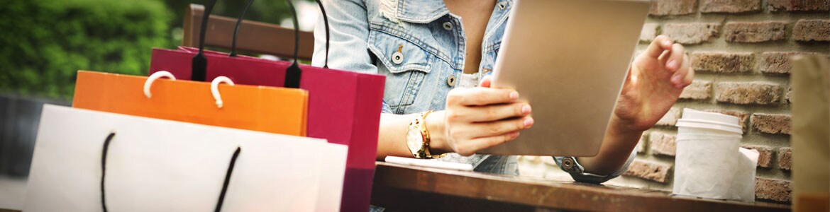 Girl sitting at coffee shop with shopping bags