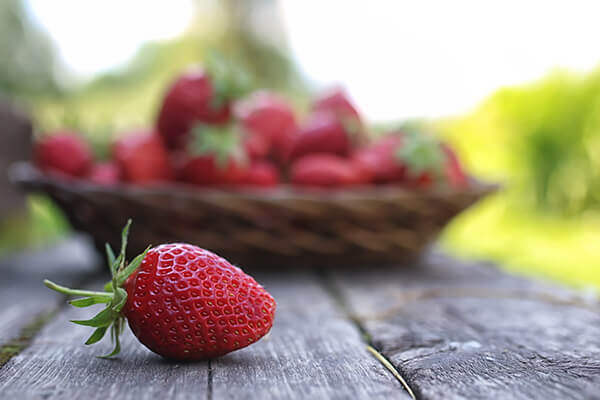 Strawberry next to a basket in Quebec