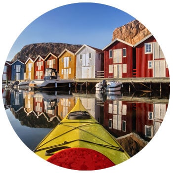 Boats on the water with houses in background