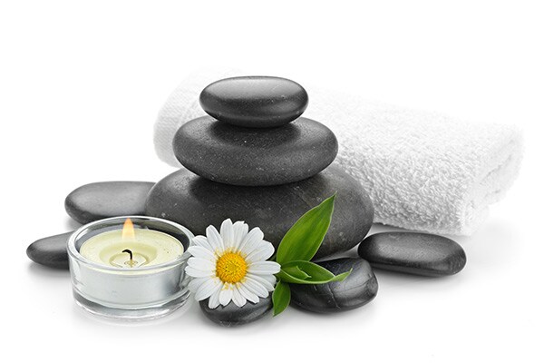 Spa arrangement with zen basalt stones, flower and candle