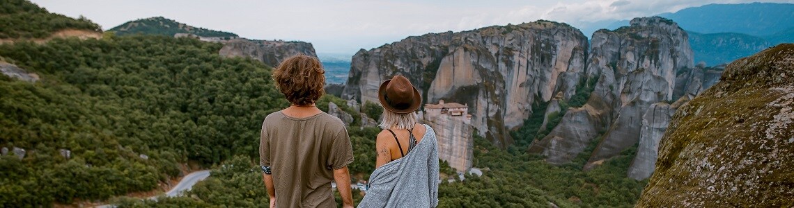 Man and woman looking out over the mountains.