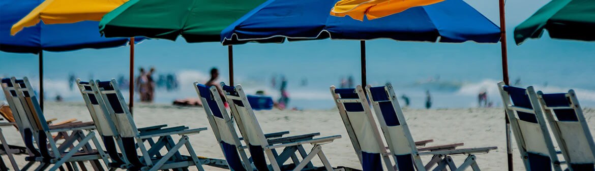 Top beach destinations with umbrellas and lounge chairs along the ocean.