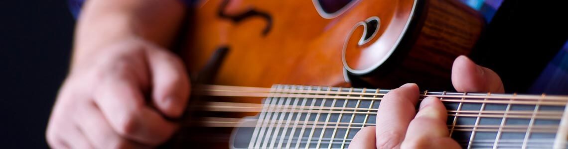 Person playing mandolin guitar in Tennessee