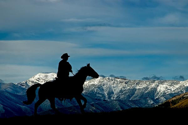 Man riding a horse in the mountains