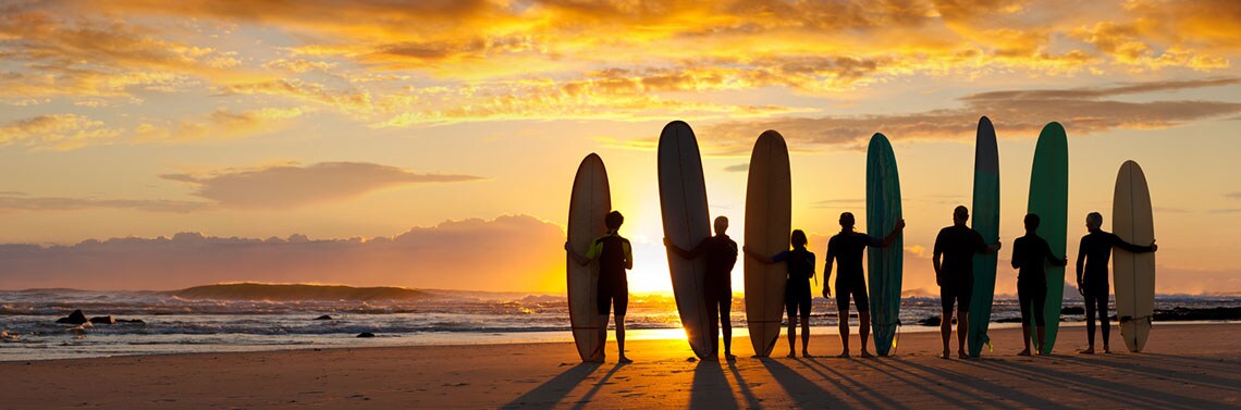 Surfers on the beach enjoying their rewards