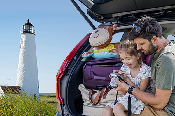 Man and Child in a Car looking at photos.