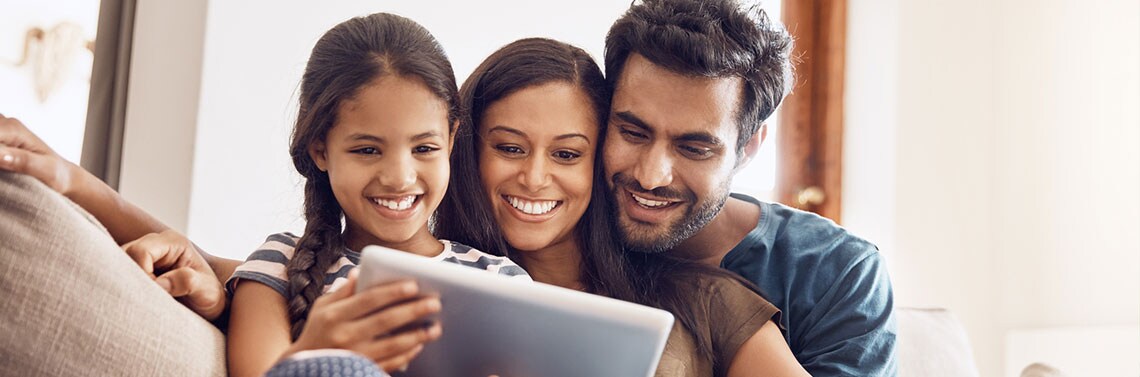 family looking at a tablet planning a vacation